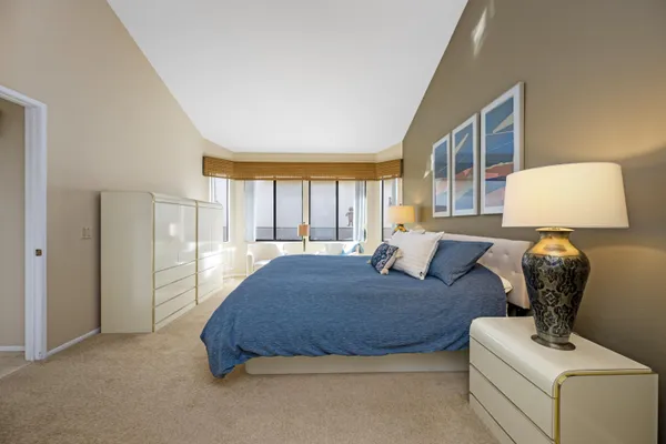 a large bathroom with a sink mirror and toilet
