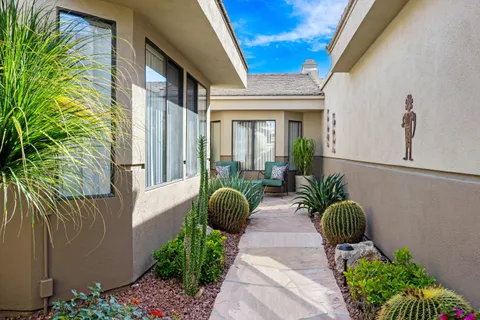 a front view of a house with garden