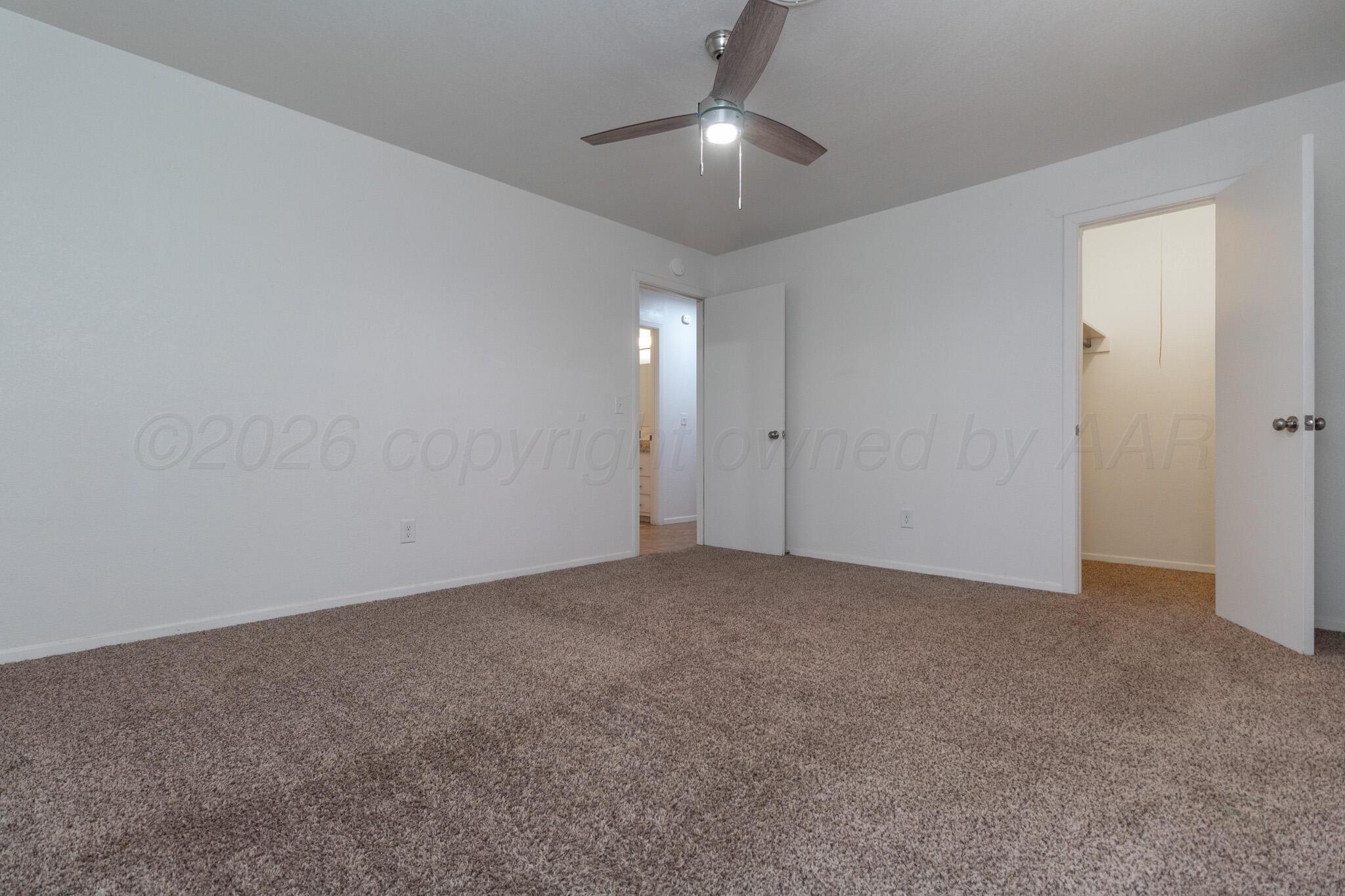 4216 Southwest 38th Avenue Amarillo, TX 79109 - Photo 12 of 19 an empty room with a chandelier fan and closet area
