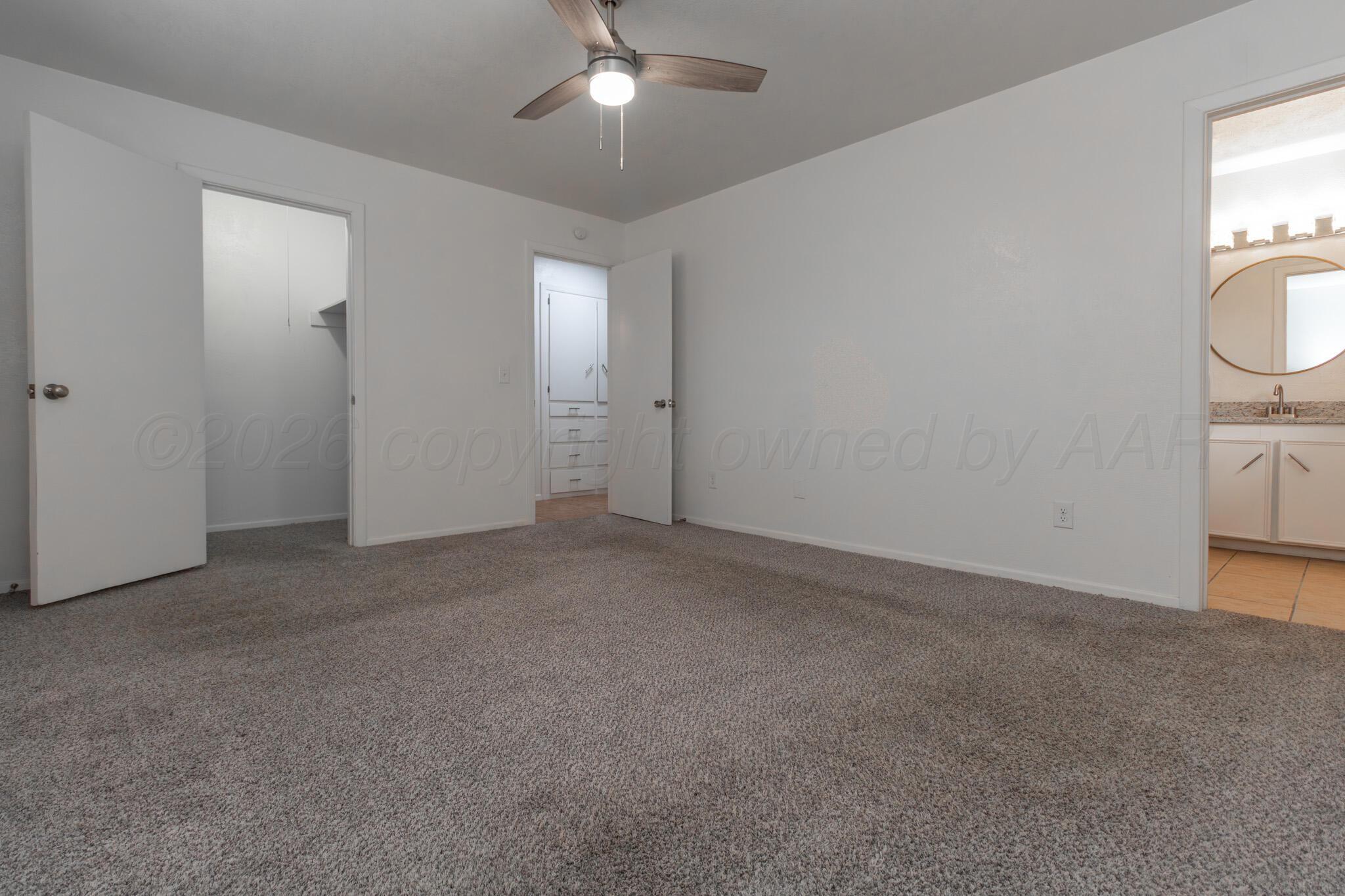 4216 Southwest 38th Avenue Amarillo, TX 79109 - Photo 16 of 19 an empty room with windows and fan