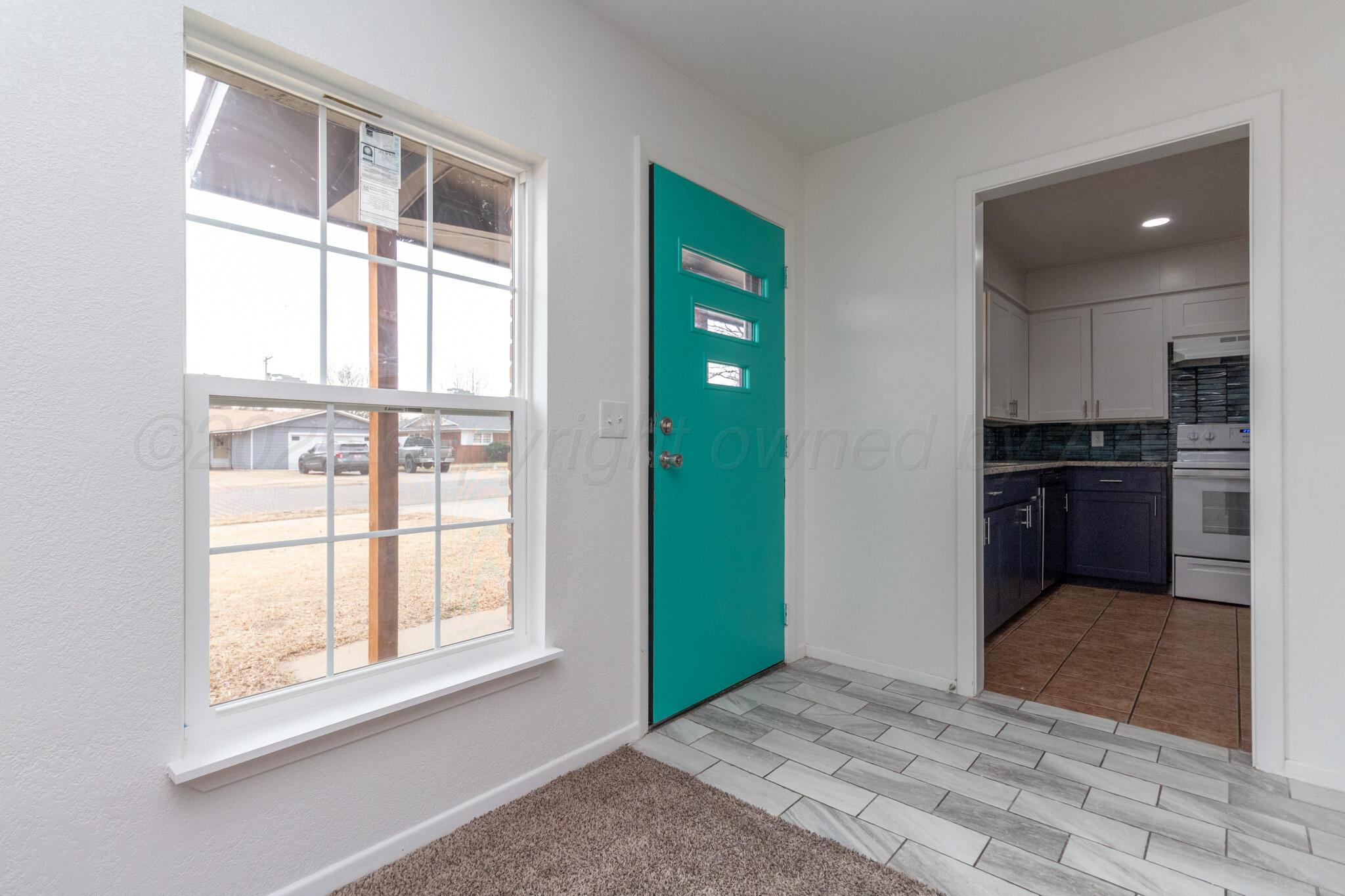 4216 Southwest 38th Avenue Amarillo, TX 79109 - Photo 4 of 19 a view of an empty room with kitchen and a window