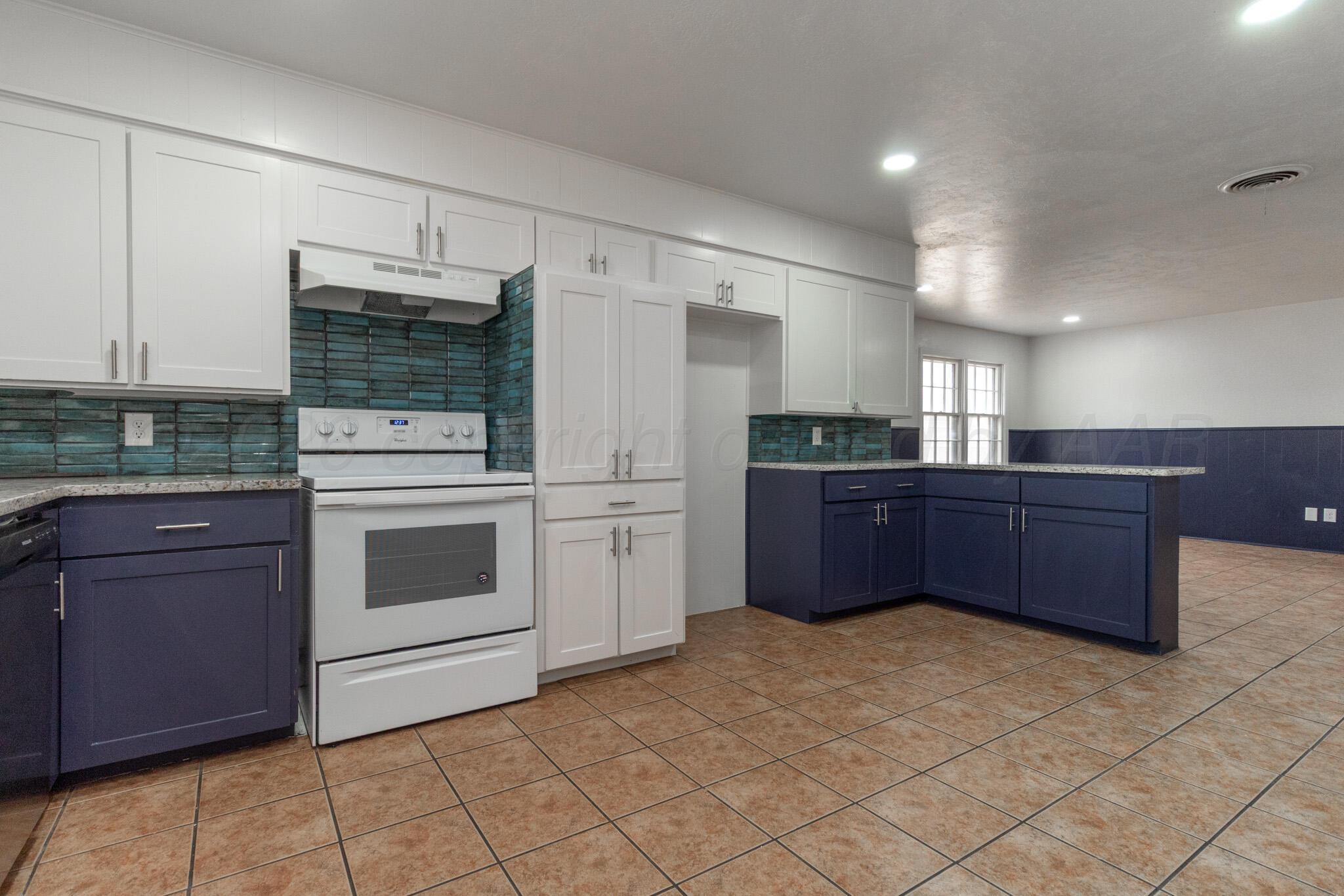 4216 Southwest 38th Avenue Amarillo, TX 79109 - Photo 6 of 19 a kitchen with a cabinets and white appliances