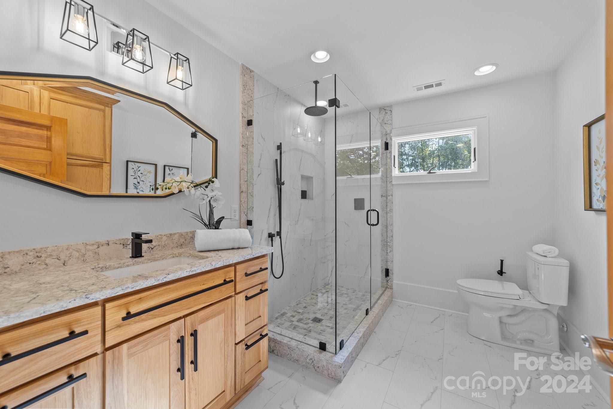 2615 Grey Road Davidson, NC 28036 - Photo 33 of 48 a bathroom with a granite countertop sink toilet and shower