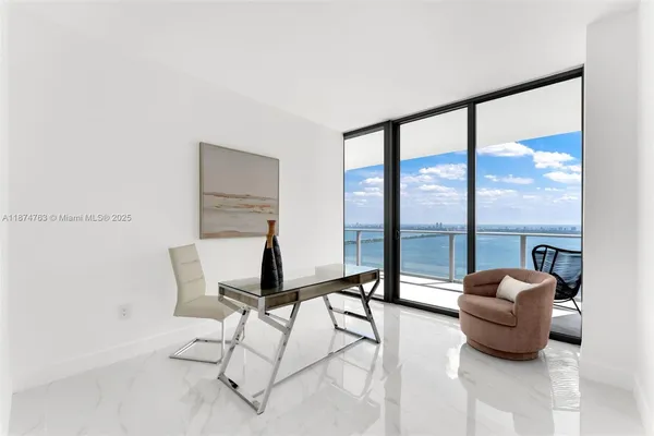 a living room with furniture and a floor to ceiling window