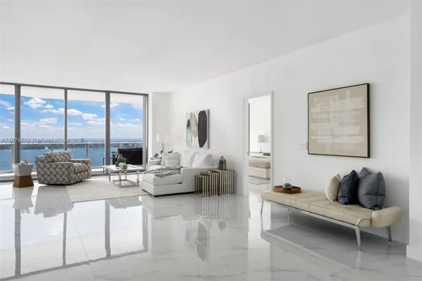 a living room with furniture and a large window
