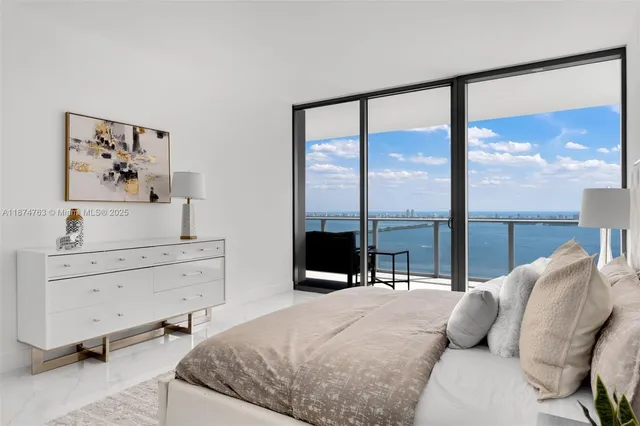 a bedroom with a bed and large window