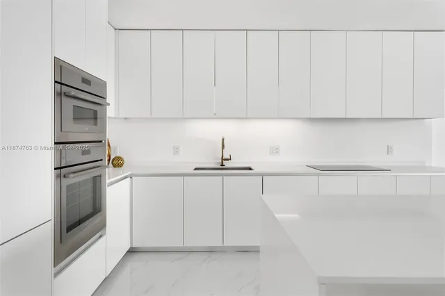 a kitchen with white cabinets and white appliances
