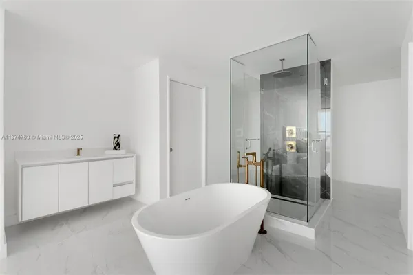 a large white tub sitting in a bathroom