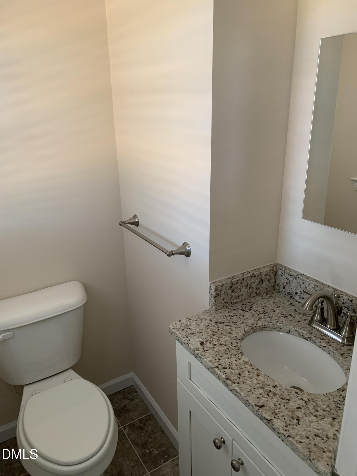 41 Tant Road Zebulon, NC 27597 - Photo 5 of 8 a bathroom with a granite countertop sink a toilet and a mirror