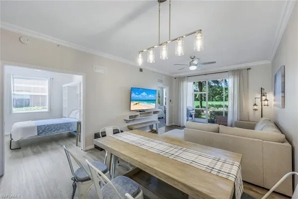 a bedroom with a bed a large window and furniture