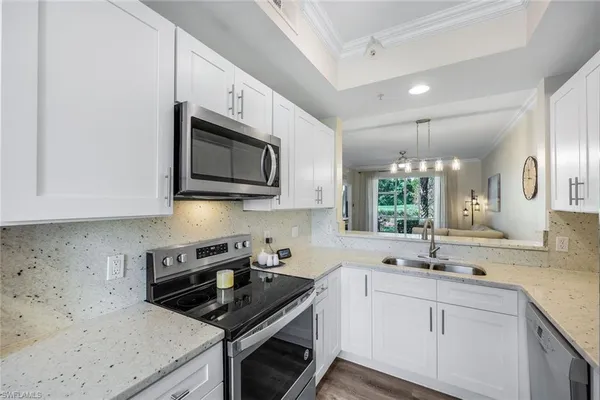 a kitchen with stainless steel appliances granite countertop a sink stove microwave and cabinets