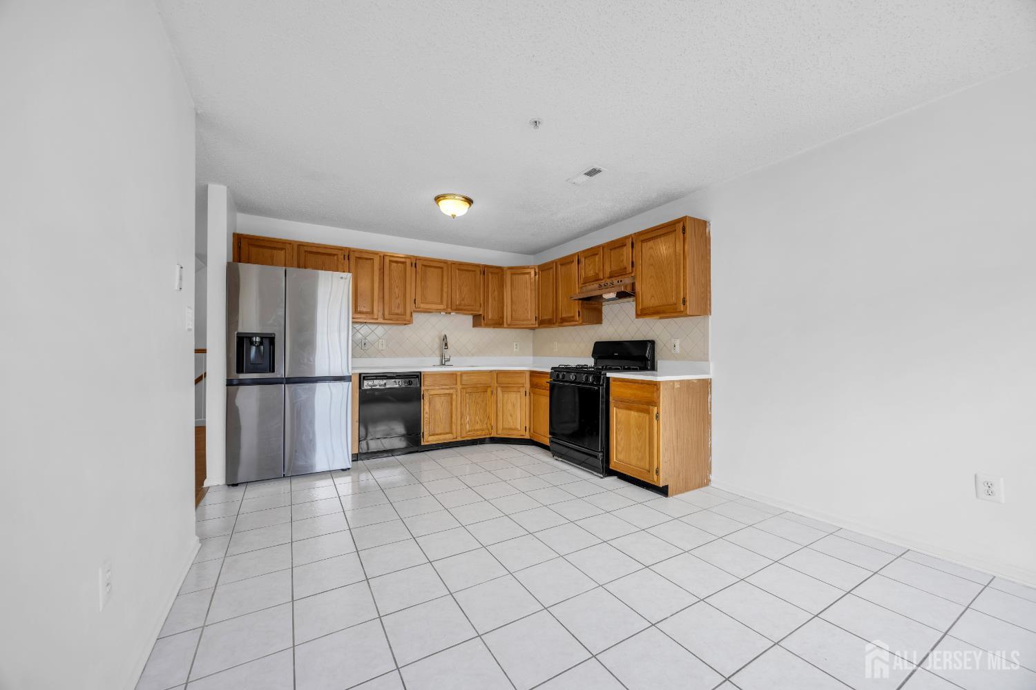 187 Prestwick Way Edison, NJ 08820 - Photo 10 of 23 a kitchen with stainless steel appliances a sink and a refrigerator