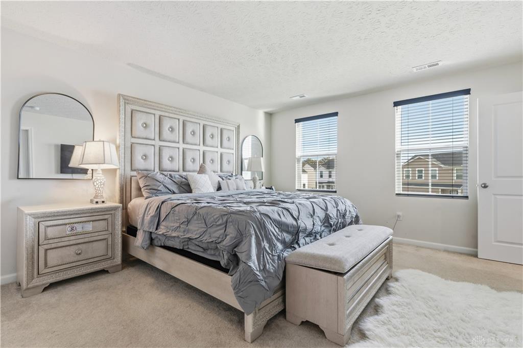 166 Chesapeake Circle Springfield, OH 45505 - Photo 3 of 15 This inviting bedroom offers plush carpeting and natural light, perfect for serene living.