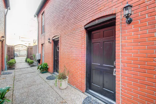 a front view of a house with potted plants