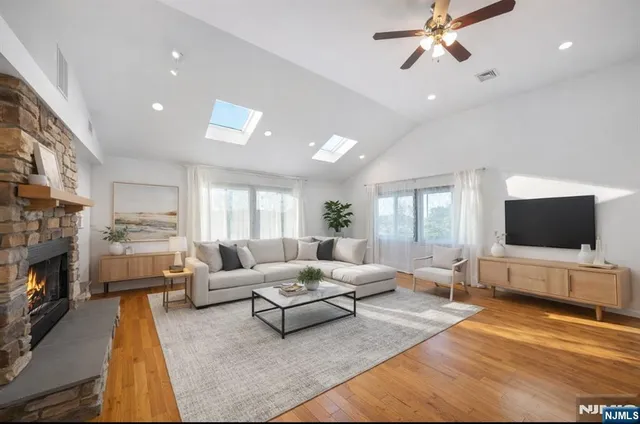 a living room with fireplace furniture and a flat screen tv