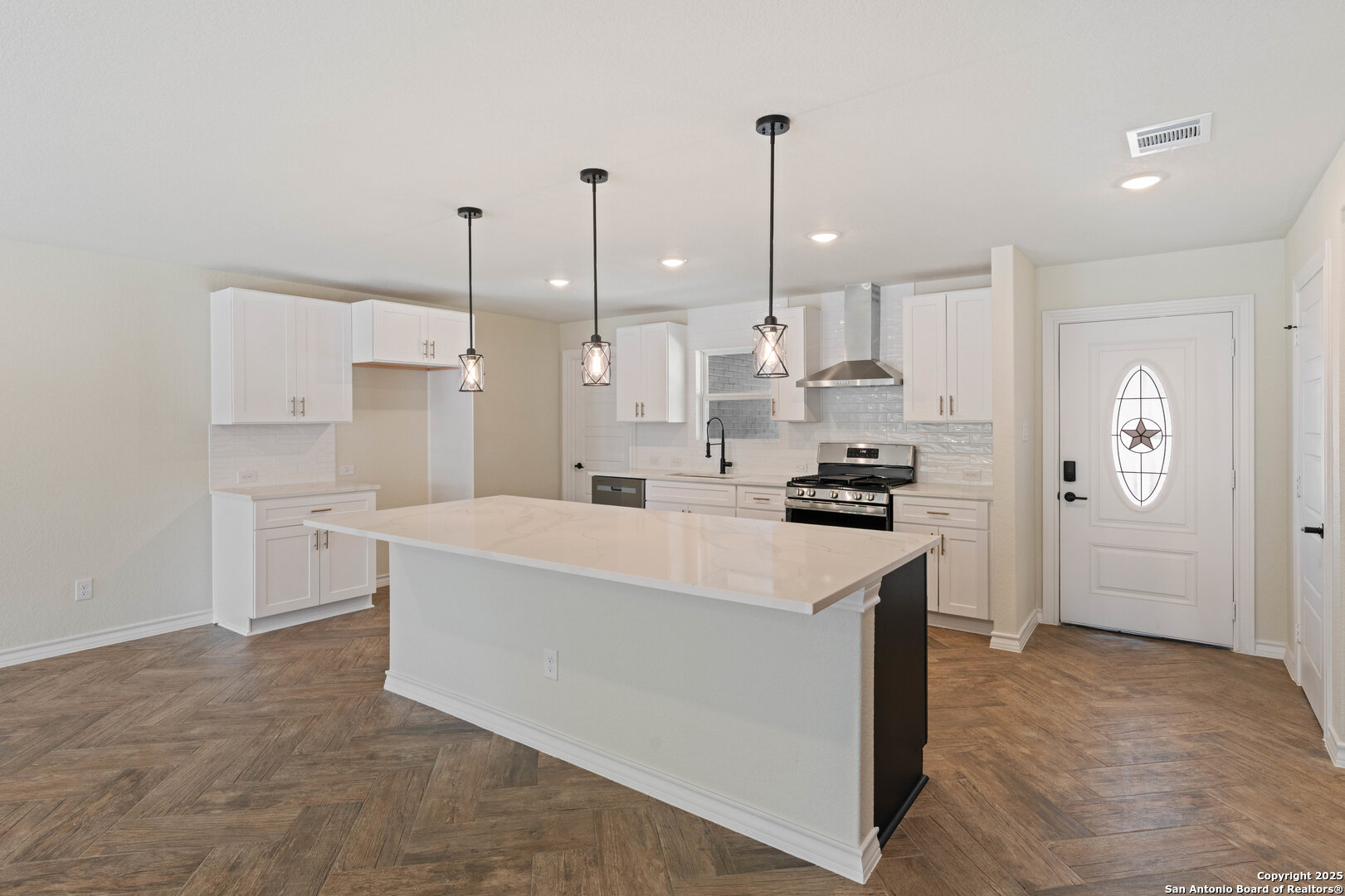 246 Sprucewood Lane San Antonio, TX 78216 - Photo 11 of 42 a kitchen with stainless steel appliances kitchen island a refrigerator sink and cabinets