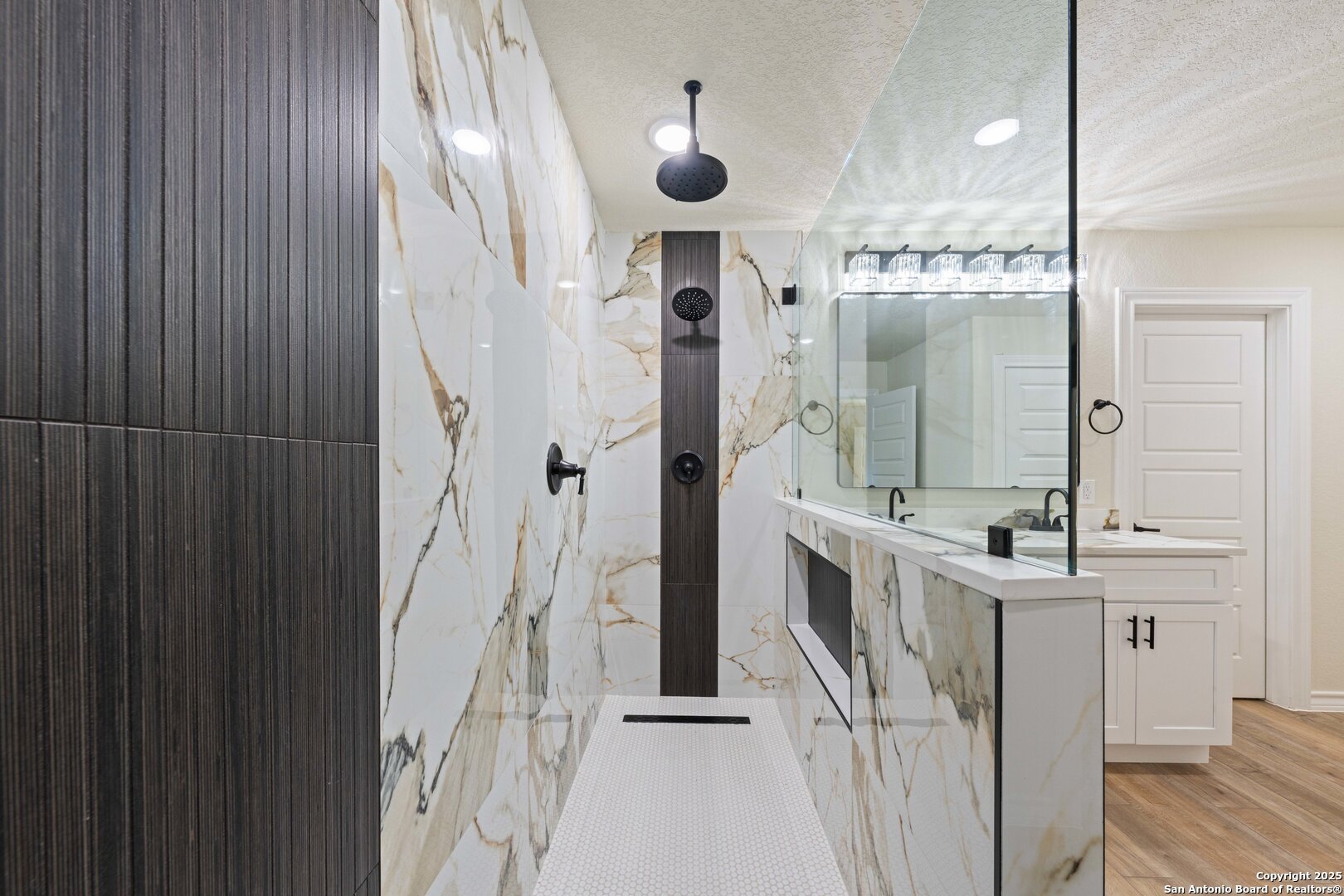 246 Sprucewood Lane San Antonio, TX 78216 - Photo 23 of 42 a bathroom with a double vanity sink mirror and shower