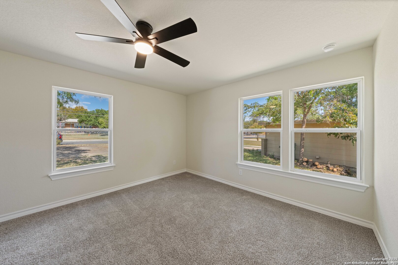 246 Sprucewood Lane San Antonio, TX 78216 - Photo 27 of 42 a view of an empty room with a window and a ceiling fan