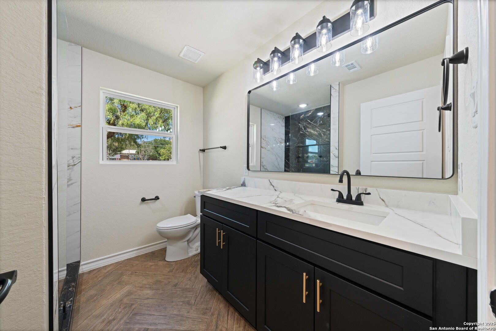 246 Sprucewood Lane San Antonio, TX 78216 - Photo 28 of 42 a bathroom with a double vanity sink toilet and a mirror