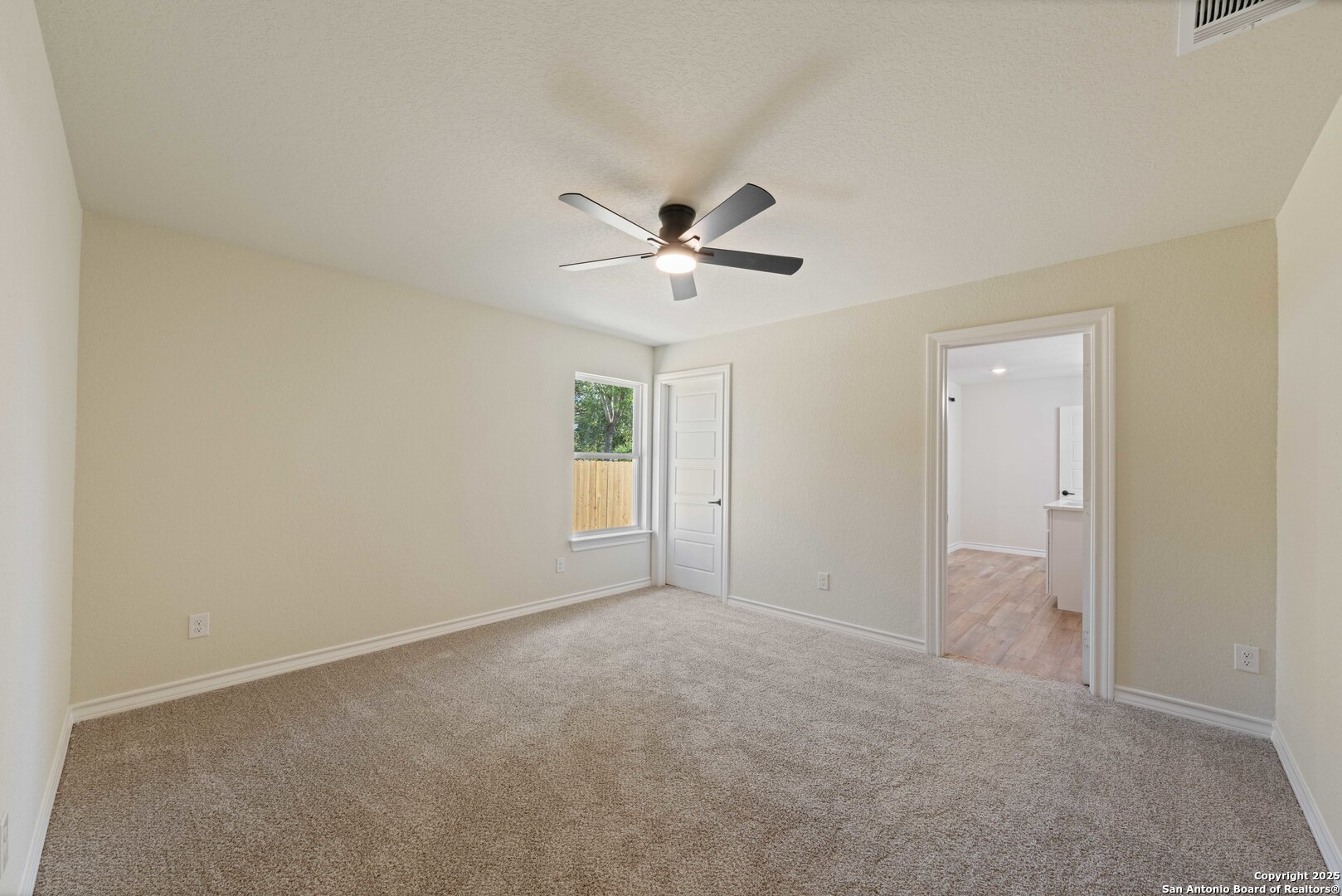 246 Sprucewood Lane San Antonio, TX 78216 - Photo 31 of 42 an empty room with a ceiling fan and a window