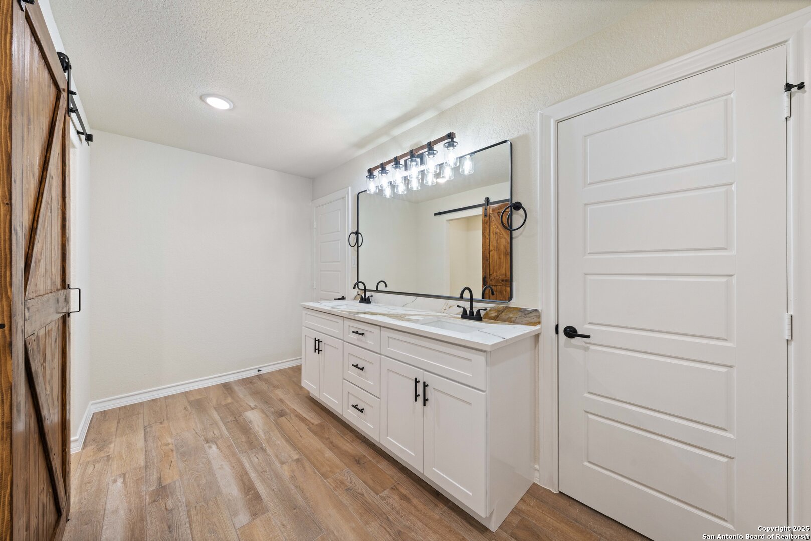 246 Sprucewood Lane San Antonio, TX 78216 - Photo 35 of 42 a bathroom with a double vanity sink and mirror