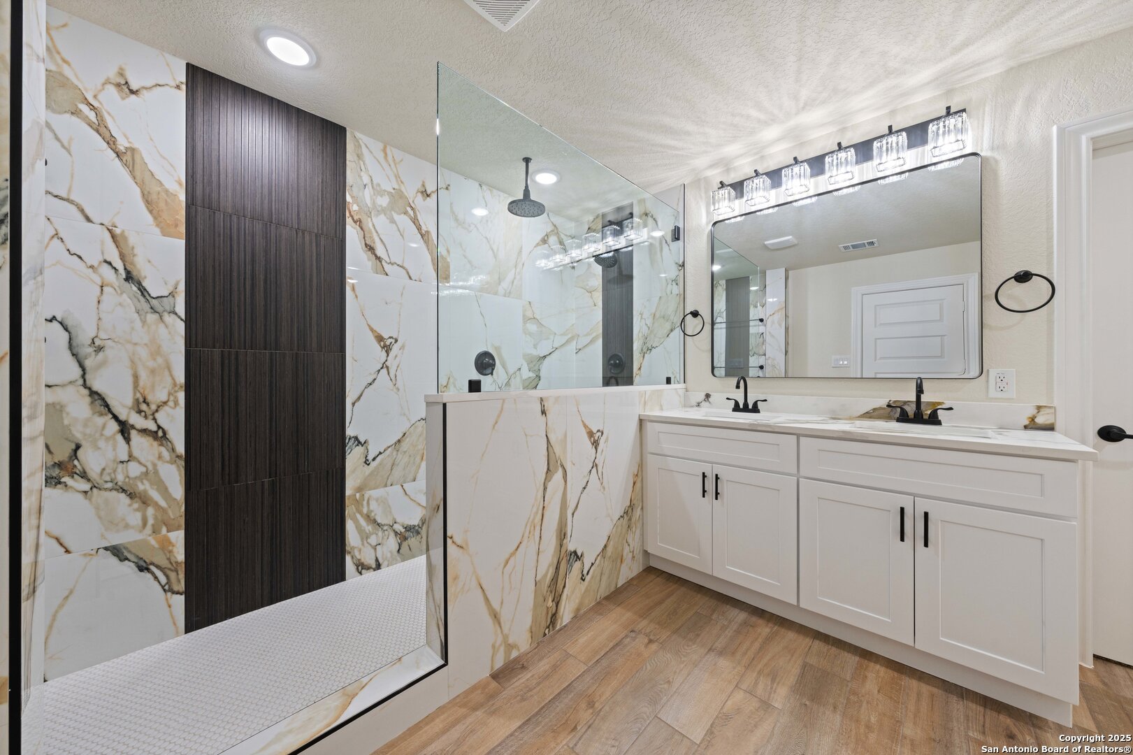 246 Sprucewood Lane San Antonio, TX 78216 - Photo 4 of 42 a spacious bathroom with a double vanity sink mirror and shower