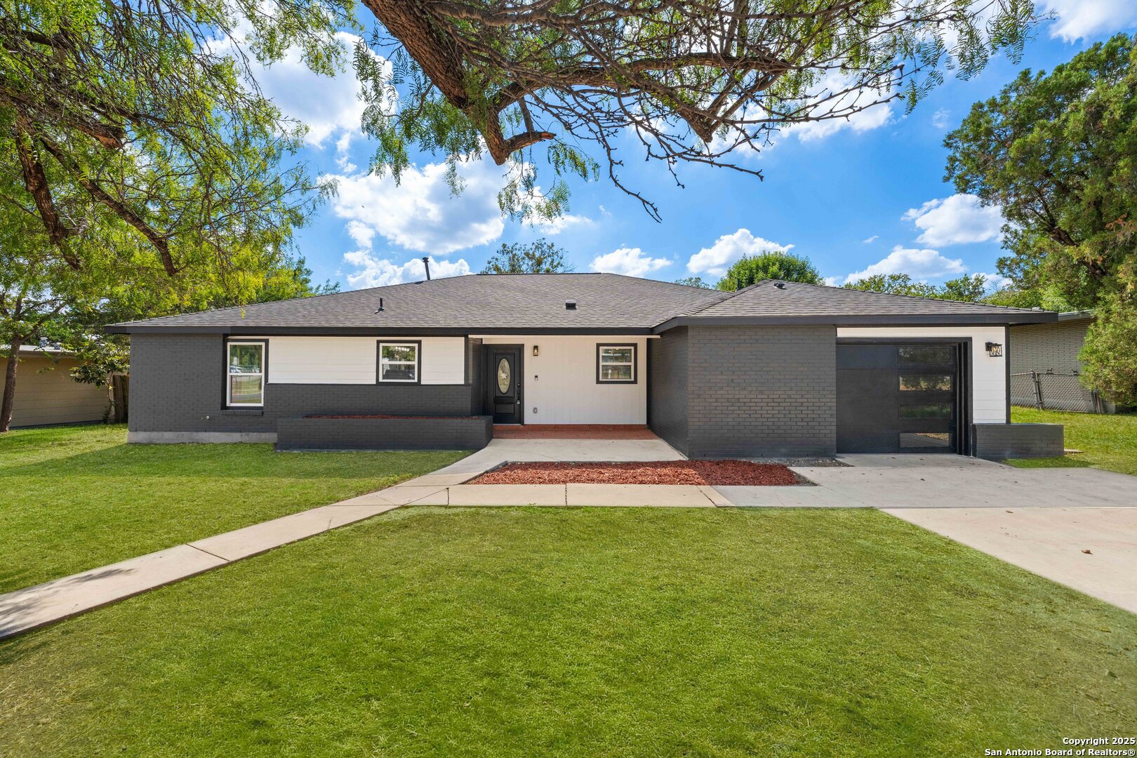 246 Sprucewood Lane San Antonio, TX 78216 - Photo 7 of 42 a front view of a house with a yard and garage