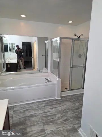 a spacious bathroom with a tub and shower