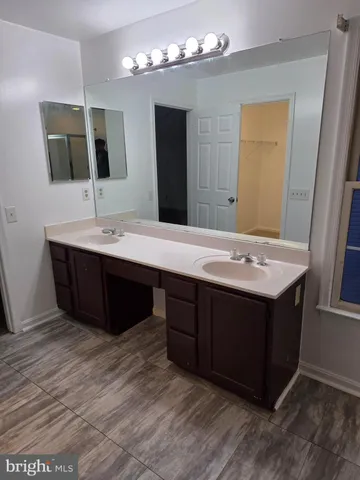 a bathroom with a sink double vanity and a mirror
