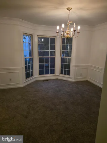 a view of a room with windows and chandelier