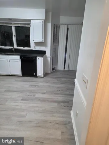 a view of a utility room with wooden floor and staircase