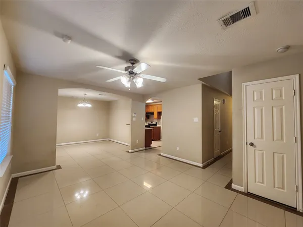 a view of a livingroom with a ceiling fan and window