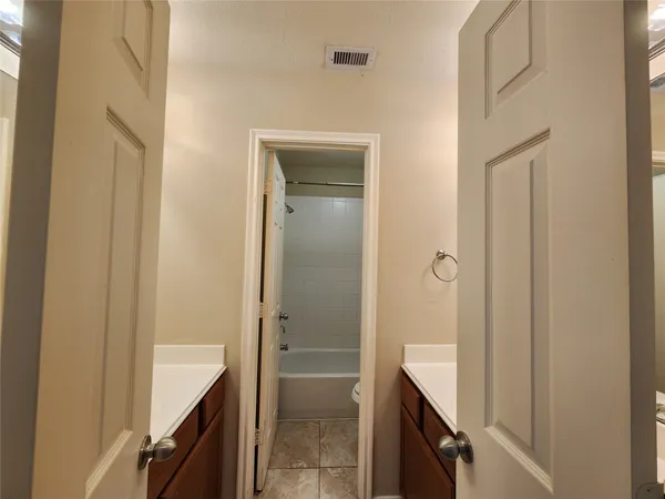 a bathroom with a shower and a sink