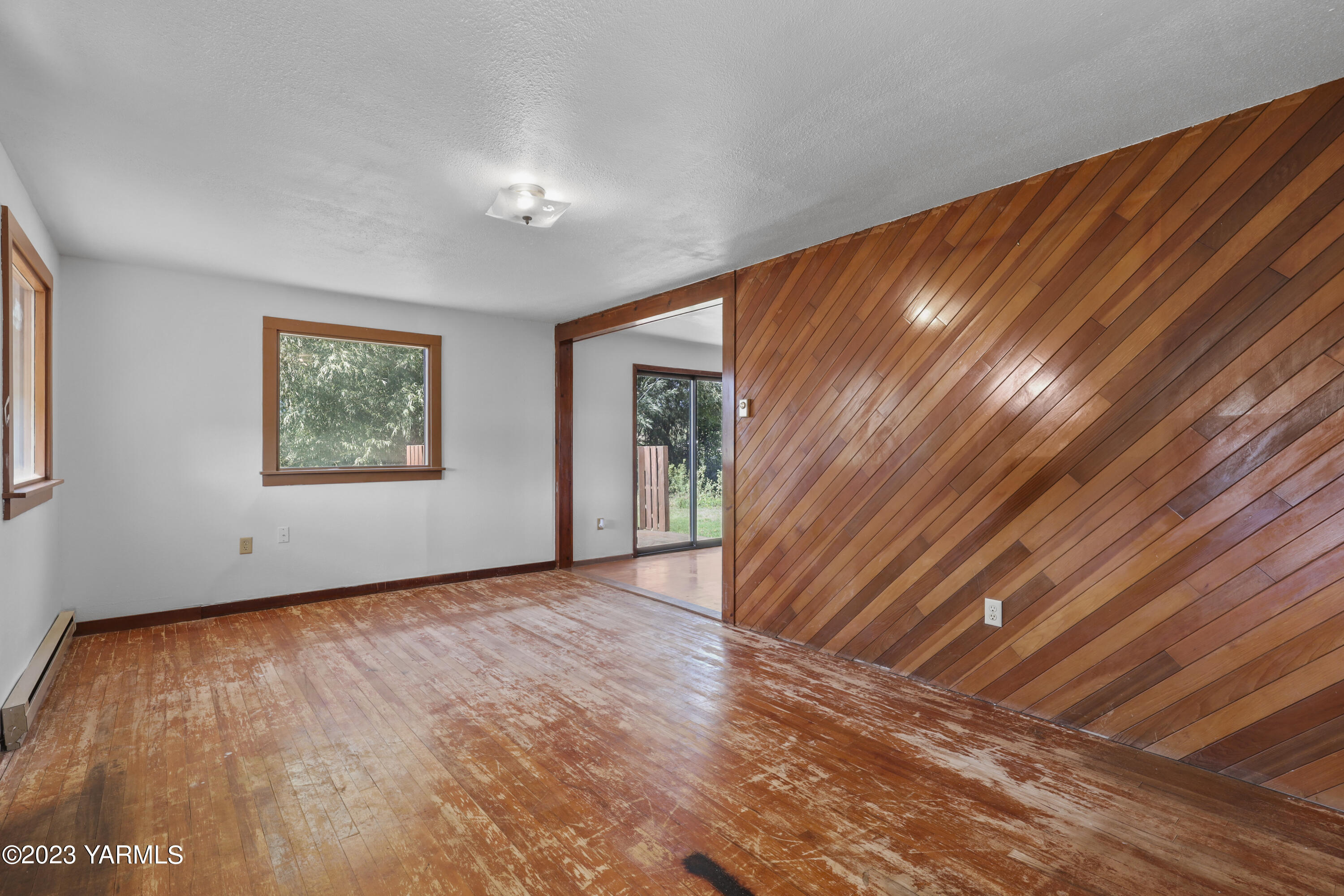 17271 Summitview Road Cowiche, WA 98923 - Photo 6 of 20 a view of an empty room with wooden floor and a window