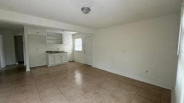 an empty room with closet and windows