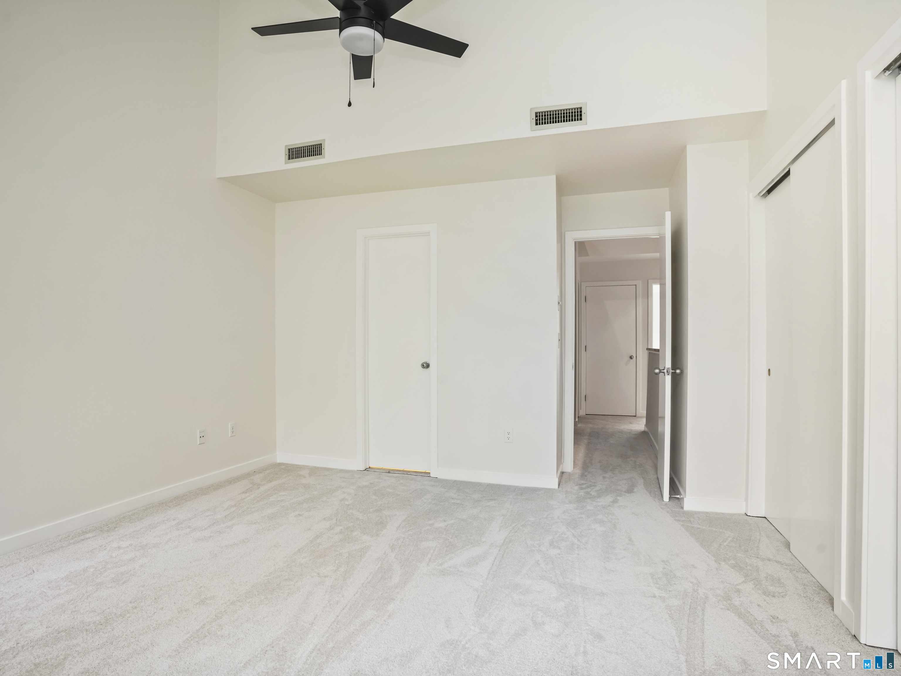 15 Perry Avenue, Unit D10 Norwalk, CT 06850 - Photo 14 of 23 an empty room with a ceiling fan and bathroom