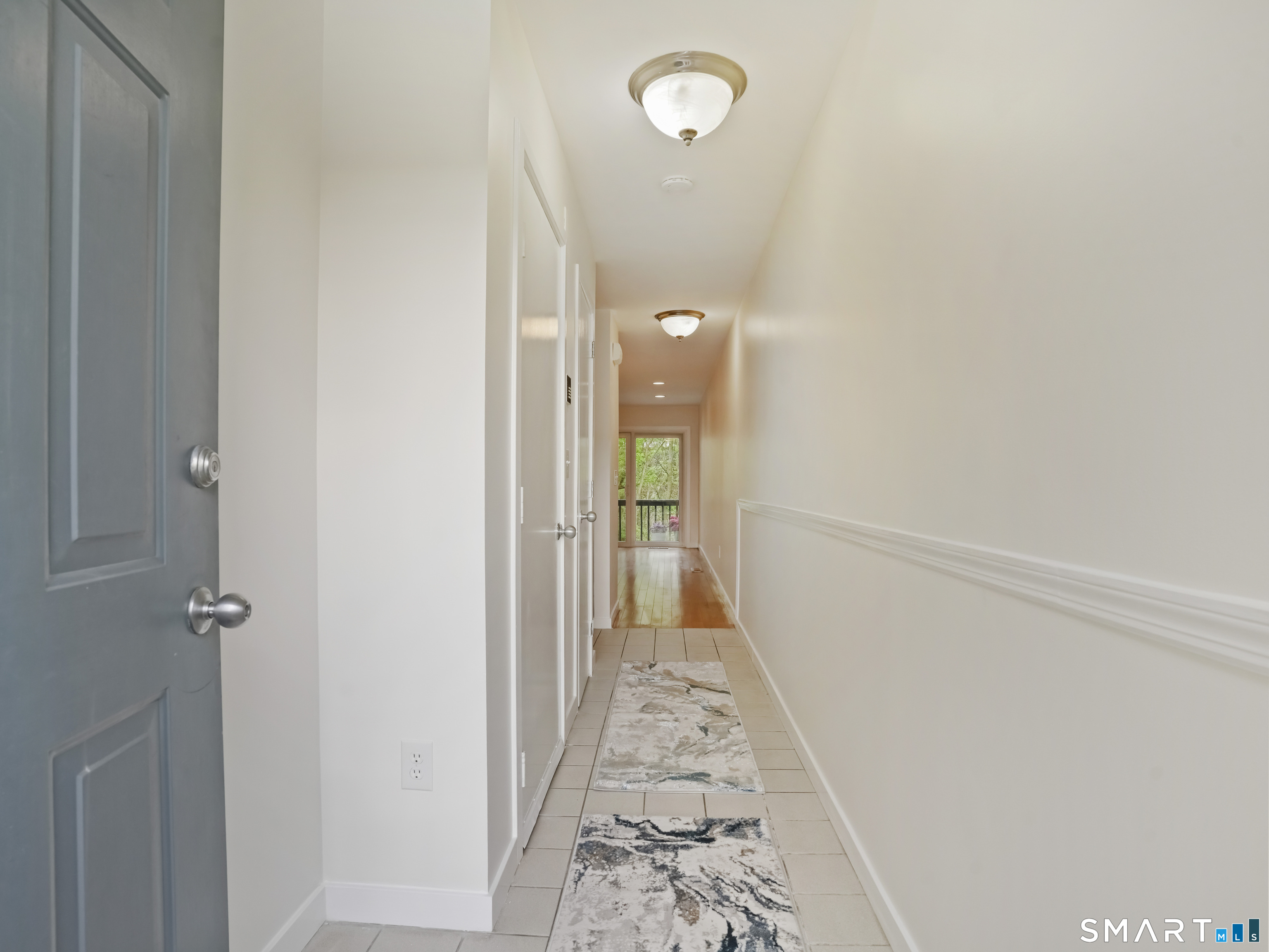 15 Perry Avenue, Unit D10 Norwalk, CT 06850 - Photo 4 of 23 a view of a hallway with wooden floor and a bathroom