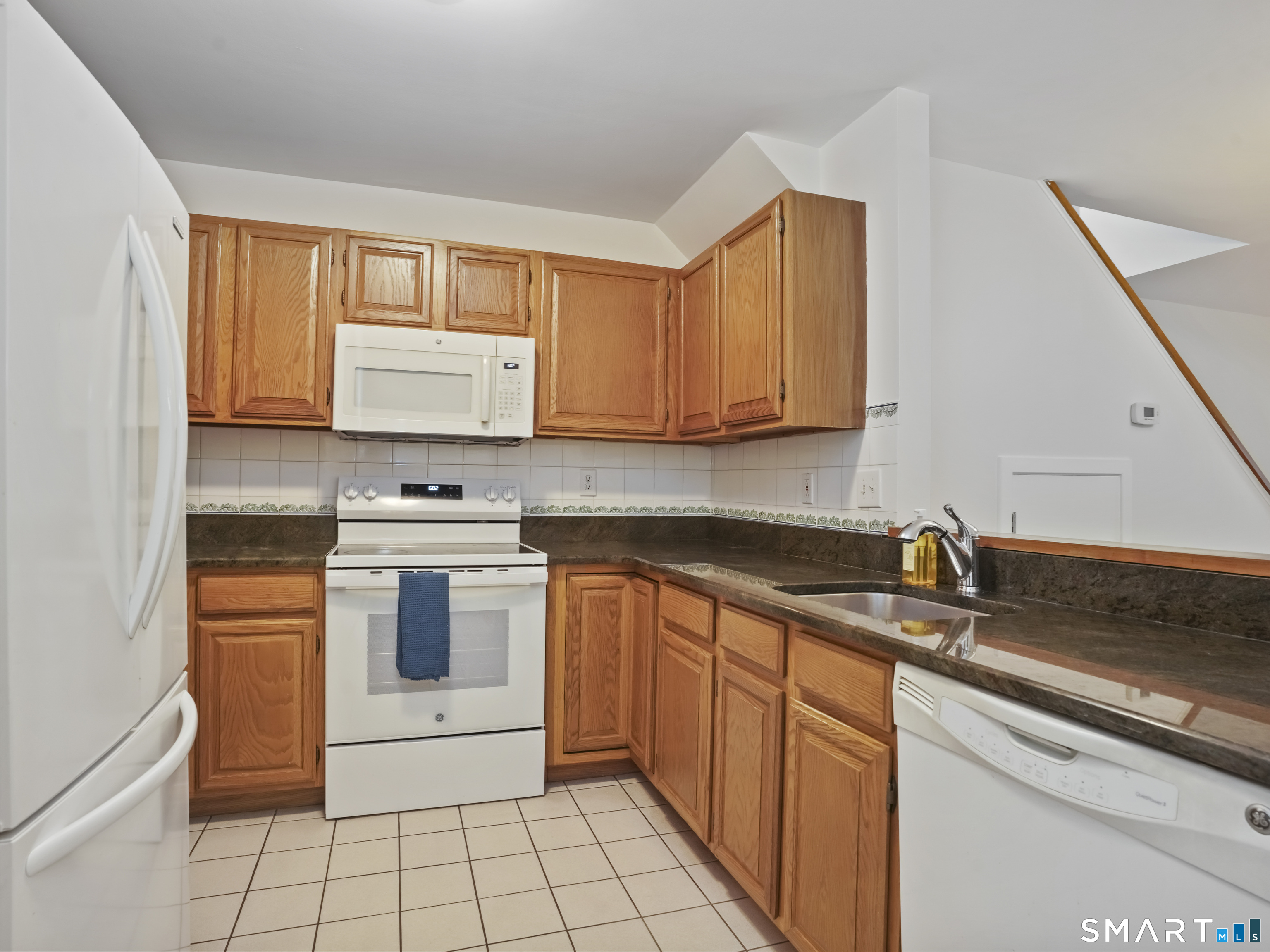 15 Perry Avenue, Unit D10 Norwalk, CT 06850 - Photo 5 of 23 a kitchen with stainless steel appliances granite countertop a sink stove and cabinets
