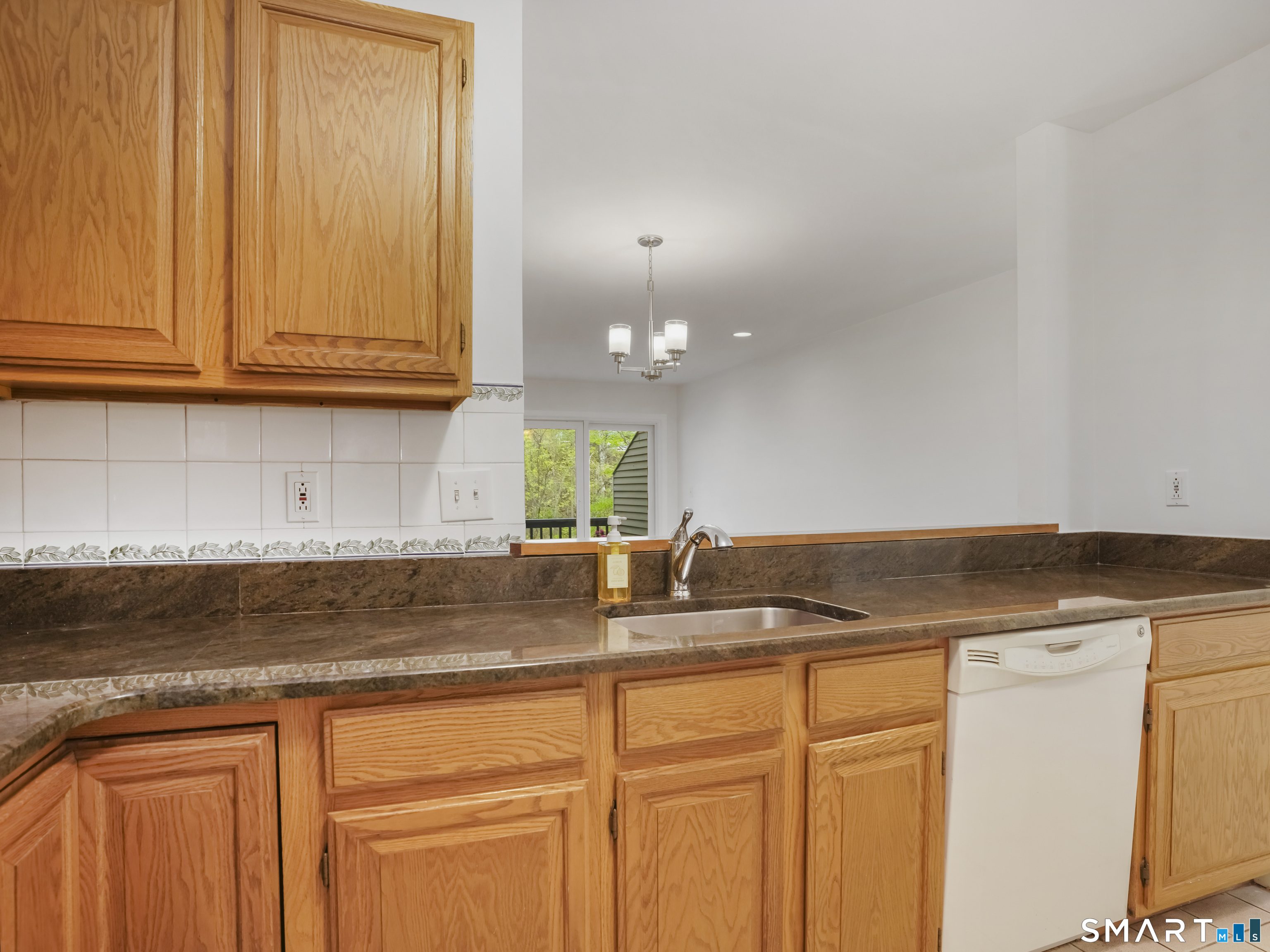 15 Perry Avenue, Unit D10 Norwalk, CT 06850 - Photo 6 of 23 a kitchen with granite countertop white cabinets and a sink