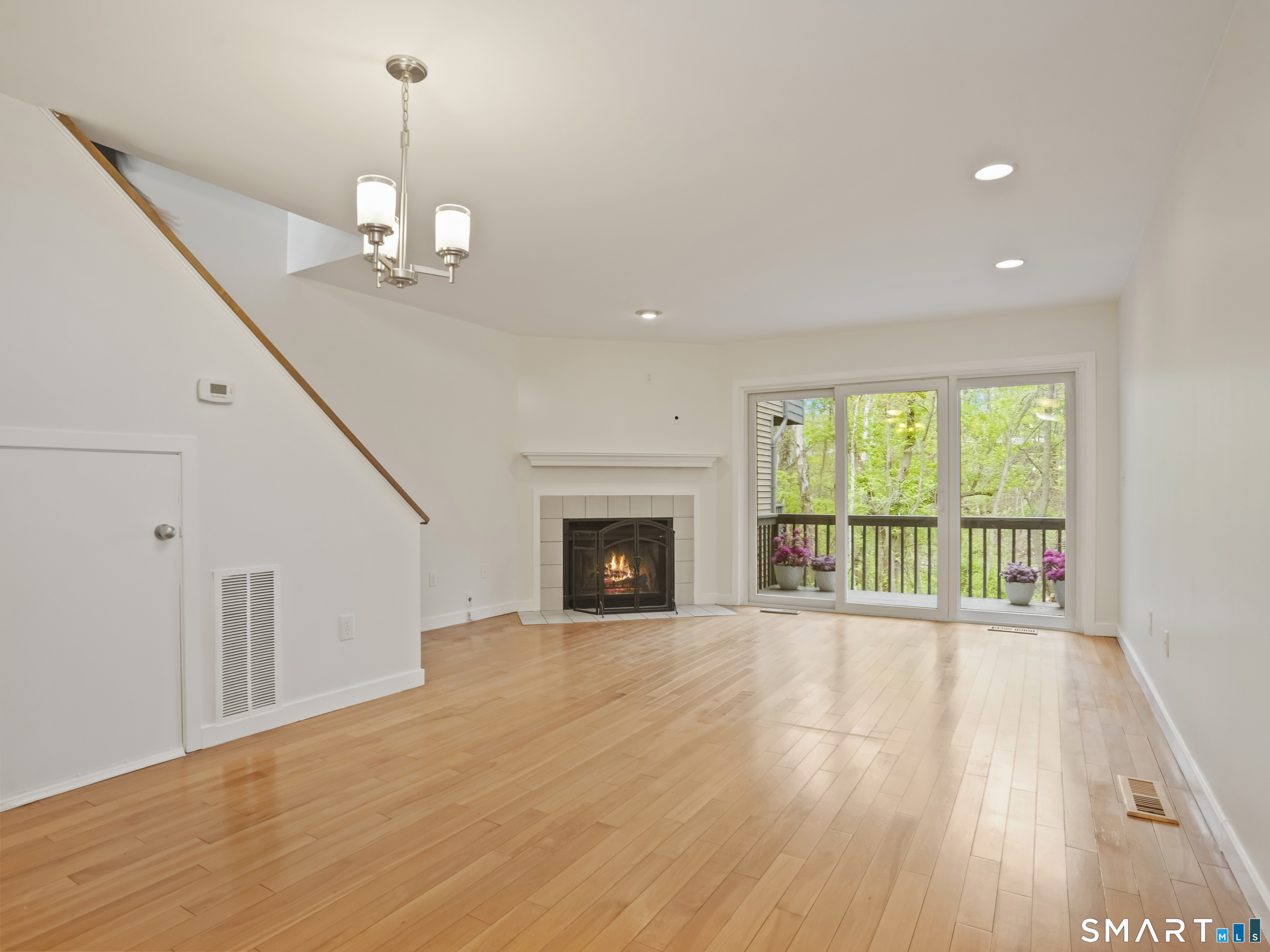 15 Perry Avenue, Unit D10 Norwalk, CT 06850 - Photo 7 of 23 a view of an empty room with wooden floor fireplace and a window