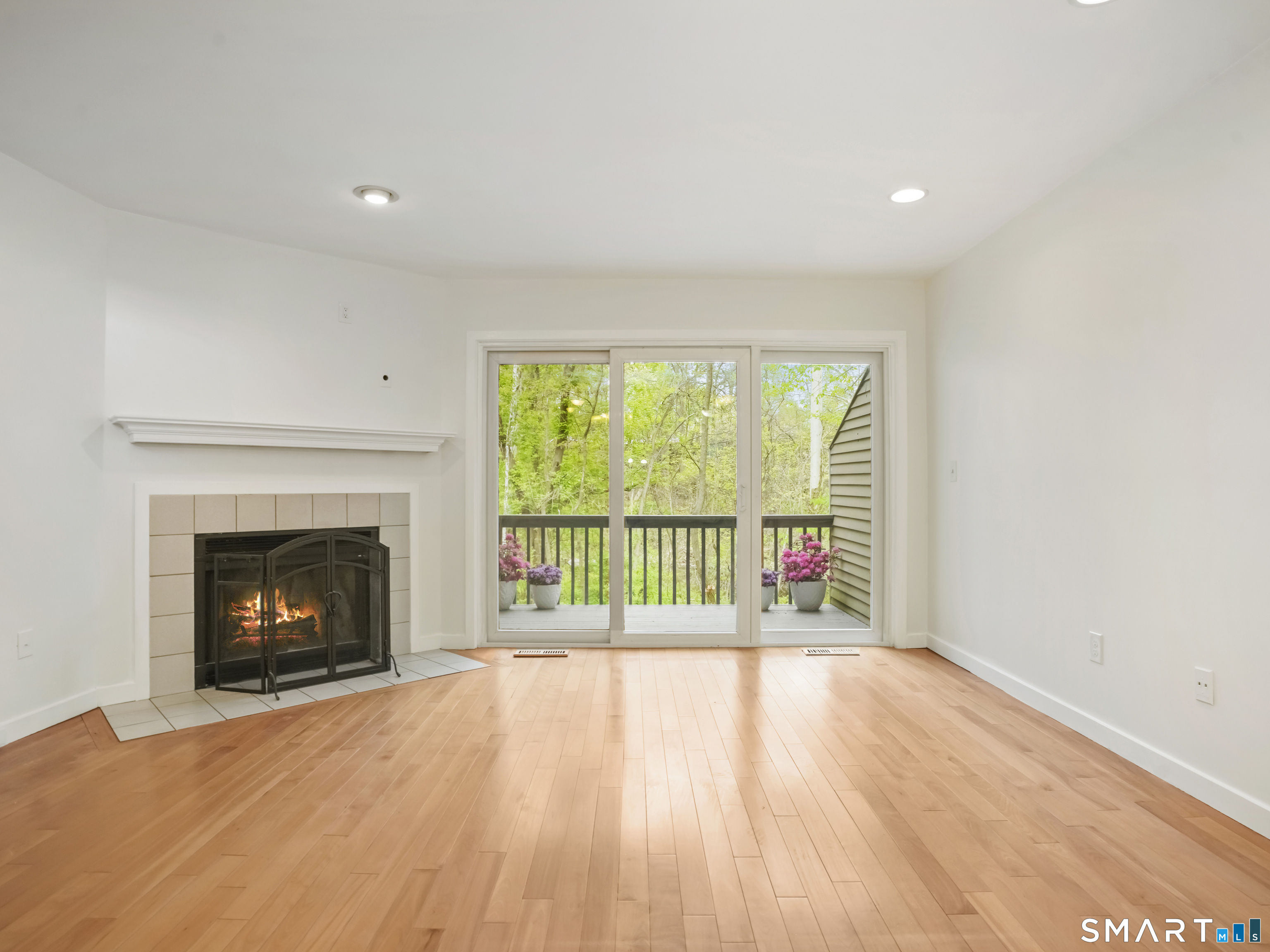 15 Perry Avenue, Unit D10 Norwalk, CT 06850 - Photo 8 of 23 a view of empty room with wooden floor and fireplace