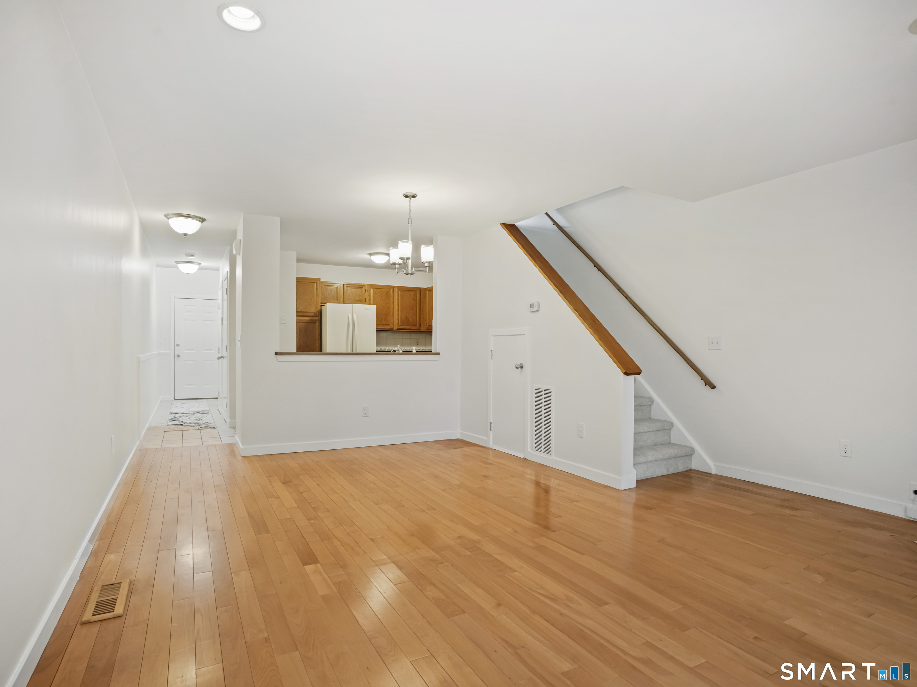 15 Perry Avenue, Unit D10 Norwalk, CT 06850 - Photo 10 of 23 a view of an empty room with wooden floor