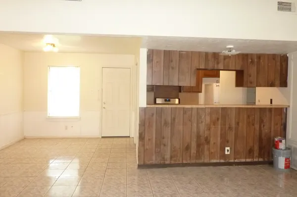 a view of kitchen with wooden cabinets