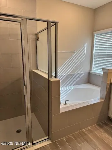 a bathroom with a shower and a tub