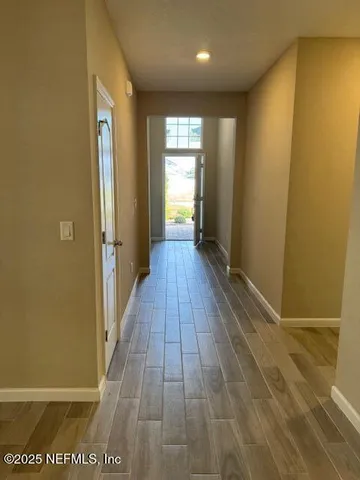 a view of a hallway with wooden floor