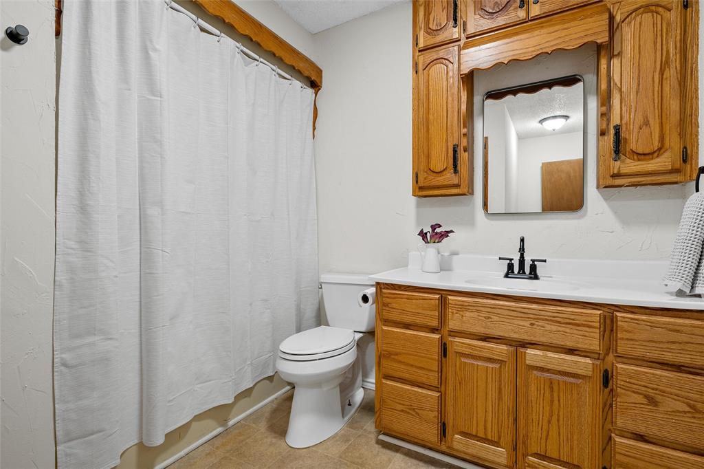 3000 North 15th A Street Waco, TX 76708 - Photo 15 of 24 a bathroom with a toilet sink vanity and mirror