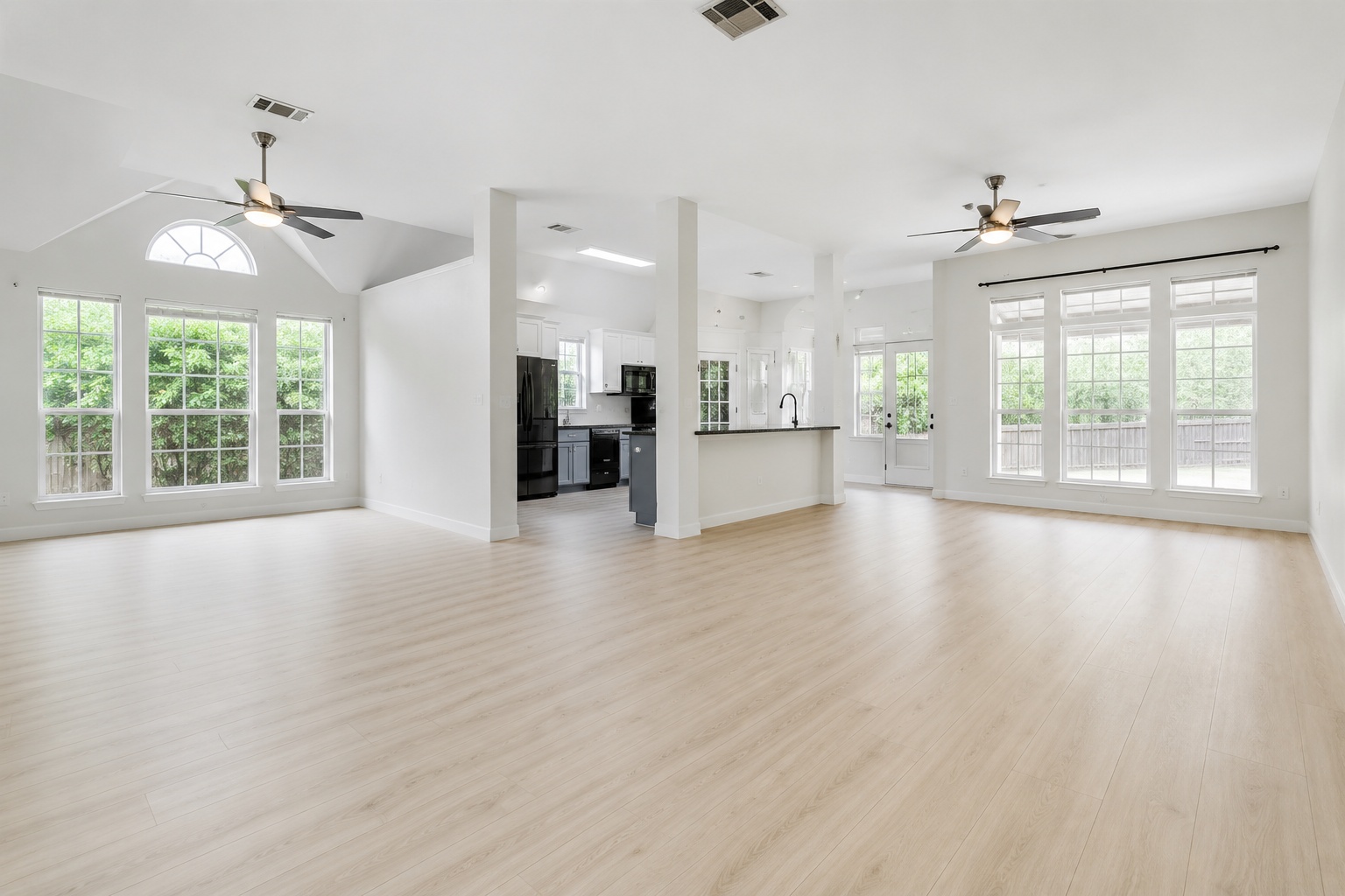 206 Gann Street Georgetown, TX 78626 - Photo 5 of 19 an empty room with wooden floor chandelier and windows