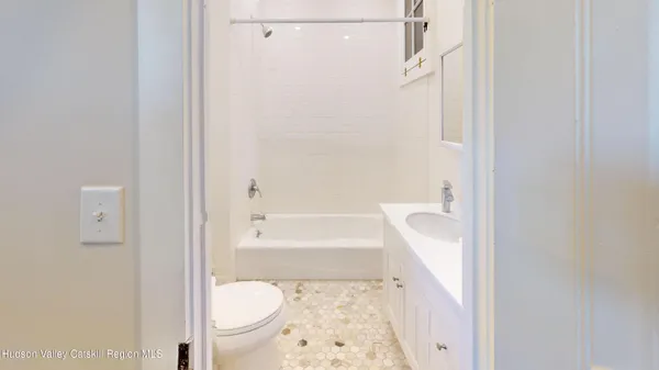 a bathroom with a tub and a toilet