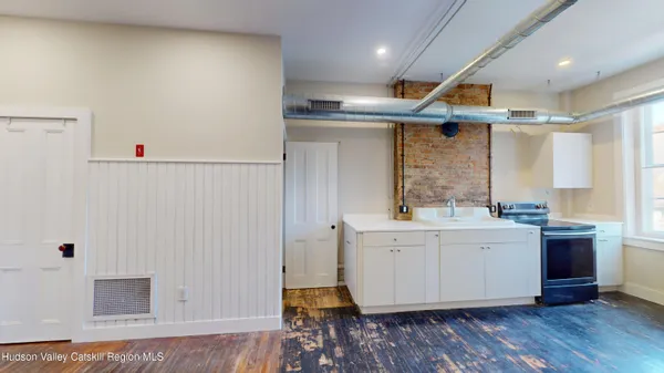 a bathroom with a sink and mirror with shower