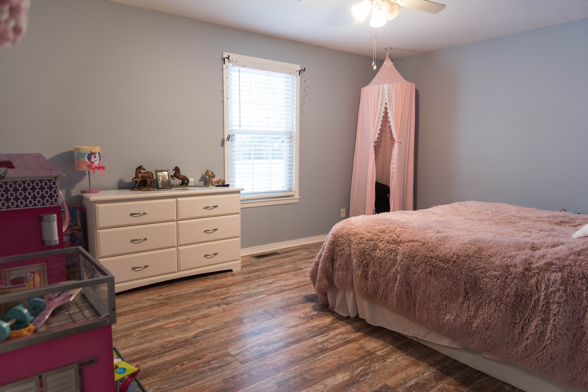 105 Biggs Road Cottontown, TN 37048 - Photo 26 of 40 a bed sitting in a bedroom next to a window with dresser